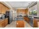 Well-lit kitchen features granite counters, stainless appliances, and center island at 3859 N El Sereno St, Mesa, AZ 85207