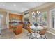 Well-lit kitchen and dining area with stainless steel appliances and a view, creating a cozy atmosphere at 3859 N El Sereno St, Mesa, AZ 85207