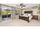 Bright primary bedroom with a king bed and access to a balcony at 3859 N El Sereno St, Mesa, AZ 85207