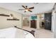 Main bedroom with floating shelves, TV, and decorative barn door to the bathroom at 3859 N El Sereno St, Mesa, AZ 85207