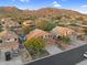 Scenic aerial view of a neighborhood nestled against the backdrop of majestic mountains at 3859 N El Sereno St, Mesa, AZ 85207