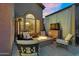 Relaxing outdoor patio features a fire pit, comfortable seating, and a TV for entertainment at 3859 N El Sereno St, Mesa, AZ 85207