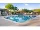 A community pool featuring lap lanes and seating areas with shaded gazebos and desert landscaping at 3859 N El Sereno St, Mesa, AZ 85207
