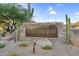 Community signage for Whispering Ridge, with desert landscaping including native cacti and stone accents at 3859 N El Sereno St, Mesa, AZ 85207