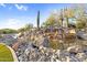 Artificial rock water feature and surrounding rock with light blue sky background at 3859 N El Sereno St, Mesa, AZ 85207