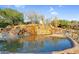 Water feature including a beautiful stone waterfall surrounded by desert landscaping at 3859 N El Sereno St, Mesa, AZ 85207