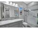 Modern bathroom showcasing a spacious shower, gray vanity, and sleek design elements at 41465 W Sussex Dr, Maricopa, AZ 85138