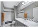 Modern bathroom featuring gray cabinetry, mosaic tile accents, and a bathtub with shower at 41465 W Sussex Dr, Maricopa, AZ 85138