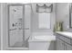 Bathroom showcasing a glass-enclosed shower, soaking tub, and neutral color scheme for a serene atmosphere at 41465 W Sussex Dr, Maricopa, AZ 85138
