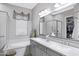 Bright bathroom with a soaking tub, double vanity, and a walk-in shower, offering a spa-like experience at 41465 W Sussex Dr, Maricopa, AZ 85138