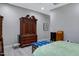 Bedroom with wood floors, large wardrobe, and bright natural light at 41465 W Sussex Dr, Maricopa, AZ 85138