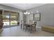 Open dining area with pendant lighting, neutral colors, and views of the landscaped backyard at 41465 W Sussex Dr, Maricopa, AZ 85138