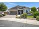 Charming single-story home featuring a lush landscaped yard and a welcoming two-car garage at 41465 W Sussex Dr, Maricopa, AZ 85138