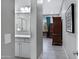 Hallway leading to a bathroom and bedroom with a dark wood dresser at 41465 W Sussex Dr, Maricopa, AZ 85138