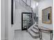 A welcoming hallway with gray walls, a staircase, and a display case at 41465 W Sussex Dr, Maricopa, AZ 85138