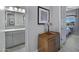 Hallway view showcases a stylish side table and a glimpse into the primary bedroom at 41465 W Sussex Dr, Maricopa, AZ 85138