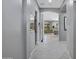 Bright hallway leading to the living room, highlighting the home's open layout and modern tile floors at 41465 W Sussex Dr, Maricopa, AZ 85138