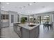 Bright kitchen featuring a large island, stainless steel appliances, and ample counter space for cooking and entertaining at 41465 W Sussex Dr, Maricopa, AZ 85138