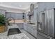 Modern kitchen featuring granite countertops, a stainless steel refrigerator, and recessed lighting at 41465 W Sussex Dr, Maricopa, AZ 85138