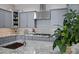 Close-up of the kitchen island featuring granite countertops, a stainless steel faucet, and lots of storage at 41465 W Sussex Dr, Maricopa, AZ 85138