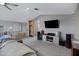 Spacious living room with modern entertainment center, vaulted ceilings, and neutral decor at 41465 W Sussex Dr, Maricopa, AZ 85138