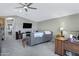 Comfortable living room with a ceiling fan, vaulted ceilings, and neutral gray colors at 41465 W Sussex Dr, Maricopa, AZ 85138