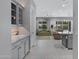 Open-concept living area featuring tile floors, neutral colors, and plenty of natural light from the backyard at 41465 W Sussex Dr, Maricopa, AZ 85138