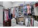 Spacious walk-in closet with built-in shelving and ample storage for clothing and accessories at 41465 W Sussex Dr, Maricopa, AZ 85138