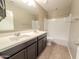 Bathroom with dual sinks, a shower-tub combo, and sleek fixtures, offering a functional design at 4277 N 180Th Ln, Goodyear, AZ 85395
