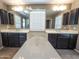 Bathroom featuring dual sinks, dark wood cabinets, an elegant bathtub, and ample counter space at 4277 N 180Th Ln, Goodyear, AZ 85395