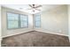 Bedroom featuring two windows for natural light, carpet, and ceiling fan at 4277 N 180Th Ln, Goodyear, AZ 85395