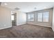 Spacious bedroom with neutral walls, plush carpeting, and plenty of natural light from dual windows at 4277 N 180Th Ln, Goodyear, AZ 85395