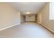 Clean garage with sealed concrete floors and a white overhead door at 4277 N 180Th Ln, Goodyear, AZ 85395