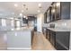A kitchen showcasing an island, granite countertops, and dark wood cabinets at 4277 N 180Th Ln, Goodyear, AZ 85395