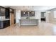 A kitchen showcasing an island, granite countertops, and dark wood cabinets at 4277 N 180Th Ln, Goodyear, AZ 85395