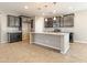 A kitchen showcasing an island, granite countertops, and dark wood cabinets at 4277 N 180Th Ln, Goodyear, AZ 85395