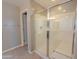 Modern bathroom with a glass-enclosed shower, a built-in bench, and neutral-colored walls at 4277 N 180Th Ln, Goodyear, AZ 85395