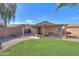 Private backyard includes a covered patio with stone pavers and desert landscaping at 43935 W Sagebrush Trl, Maricopa, AZ 85138