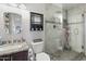 Bathroom featuring a tile shower, vanity, and a modern mirror at 43935 W Sagebrush Trl, Maricopa, AZ 85138