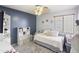 Cozy bedroom with a daybed, storage shelves, and soft natural light at 43935 W Sagebrush Trl, Maricopa, AZ 85138