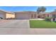 Charming single-story home featuring a two-car garage and well-maintained artificial lawn at 43935 W Sagebrush Trl, Maricopa, AZ 85138