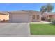 Charming single-story home featuring a two-car garage and well-maintained artificial lawn at 43935 W Sagebrush Trl, Maricopa, AZ 85138