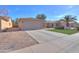 Charming single-story home featuring a two-car garage, desert landscaping and long driveway at 43935 W Sagebrush Trl, Maricopa, AZ 85138