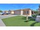 Charming single-story home featuring a two-car garage and well-maintained artificial lawn at 43935 W Sagebrush Trl, Maricopa, AZ 85138