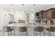 Contemporary kitchen featuring granite countertops, stainless steel appliances, and barstool seating at 43935 W Sagebrush Trl, Maricopa, AZ 85138