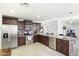Well-equipped kitchen featuring stainless steel appliances, dark cabinets, and granite countertops at 43935 W Sagebrush Trl, Maricopa, AZ 85138
