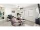 Well-lit living room with comfortable seating, ceiling fan, and neutral decor at 43935 W Sagebrush Trl, Maricopa, AZ 85138