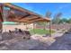Covered patio features comfortable seating and stone pavers, perfect for relaxation at 43935 W Sagebrush Trl, Maricopa, AZ 85138