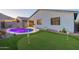 Backyard featuring pool, putting green, and desert landscaping offers a great outdoor living space at 4593 W Bush Bean Way, San Tan Valley, AZ 85144