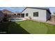 Outdoor backyard featuring a putting green, private pool, and desert landscaping at 4593 W Bush Bean Way, San Tan Valley, AZ 85144